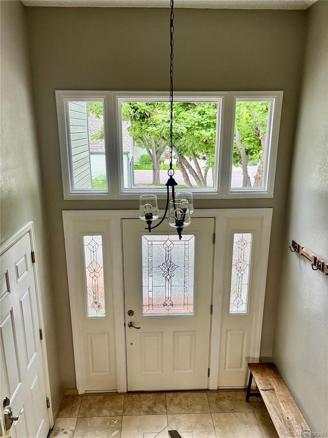5479 E Weaver Ave, Centennial, CO 80121 - entrance foyer featuring a chandelier, healthy amount of natural light, and light tile patterned floors