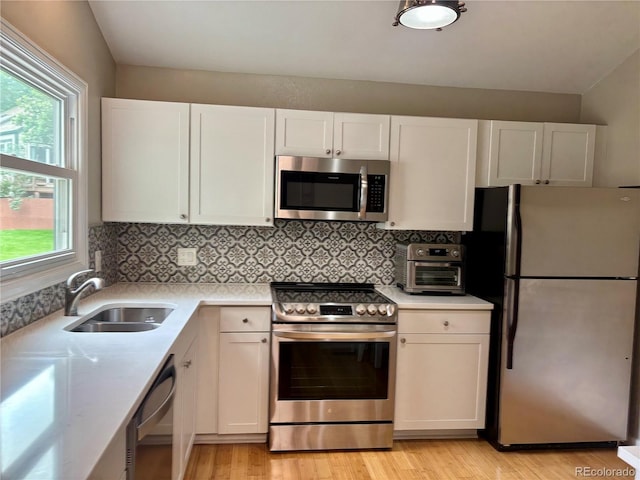 5479 E Weaver Ave, Centennial, CO 80121 - kitchen with stainless steel appliances, light countertops, and healthy amount of natural light