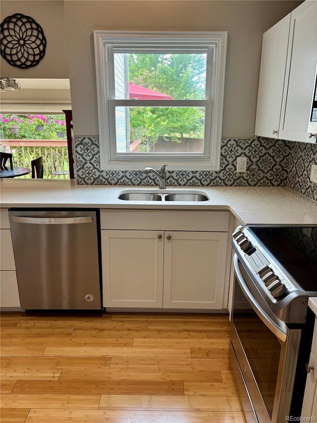 5479 E Weaver Ave, Centennial, CO 80121 - kitchen featuring appliances with stainless steel finishes, light countertops, and white cabinetry