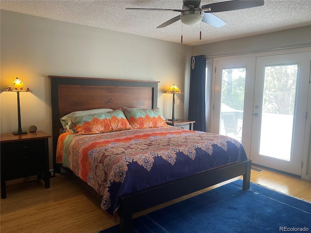 5479 E Weaver Ave, Centennial, CO 80121 - bedroom with wood finished floors, access to exterior, multiple windows, a textured ceiling, and ceiling fan