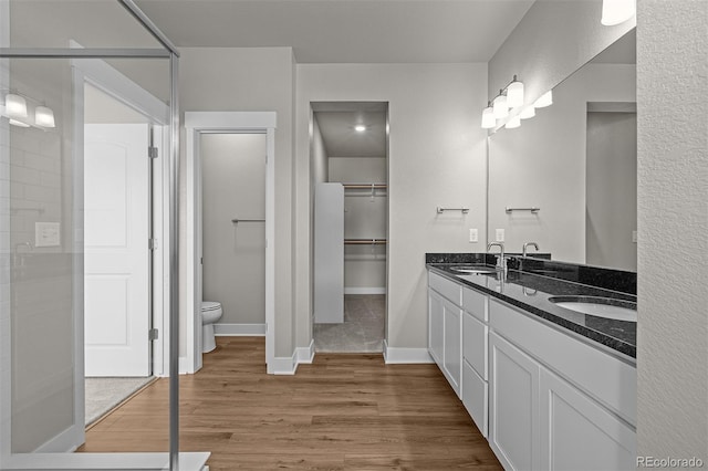 21034 E 63rd Dr, Aurora, CO 80019 - bathroom with double vanity, wood finished floors, and a spacious closet