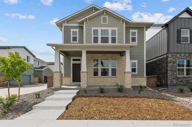 21034 E 63rd Dr, Aurora, CO 80019 - craftsman-style home with stone siding and covered porch