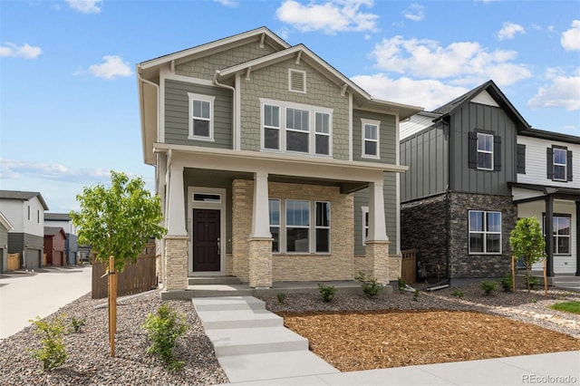 21034 E 63rd Dr, Aurora, CO 80019 - craftsman inspired home featuring stone siding, covered porch, and board and batten siding