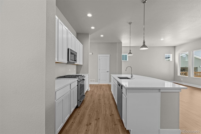 21034 E 63rd Dr, Aurora, CO 80019 - kitchen with appliances with stainless steel finishes, light wood-style floors, light countertops, and recessed lighting