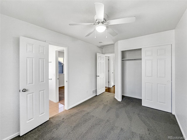 unfurnished bedroom featuring carpet floors, a closet, and ceiling fan