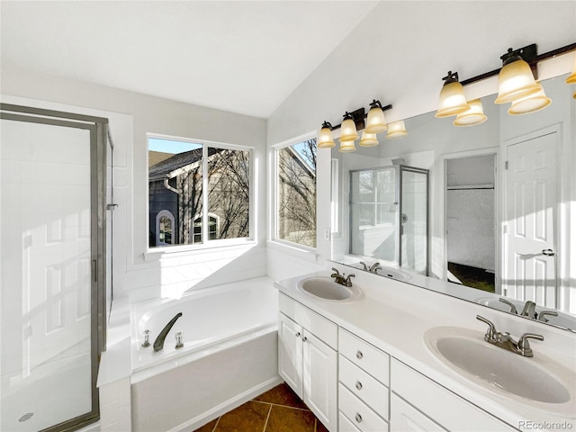 bathroom featuring tile patterned floors, vanity, lofted ceiling, and plus walk in shower