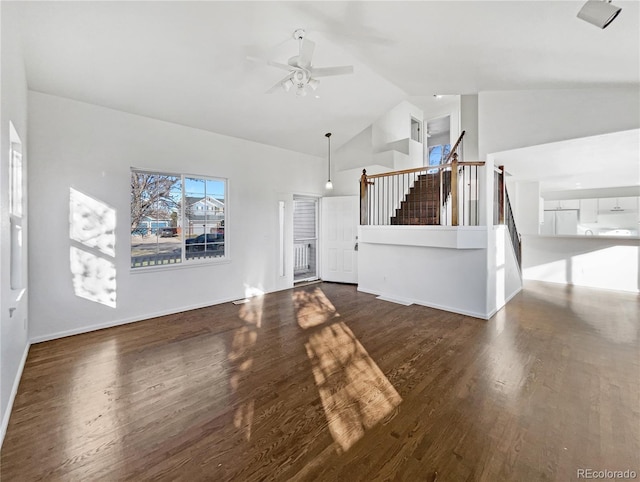 unfurnished living room with dark hardwood / wood-style floors, high vaulted ceiling, and ceiling fan