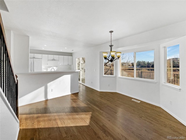 interior space with dark hardwood / wood-style floors and a chandelier