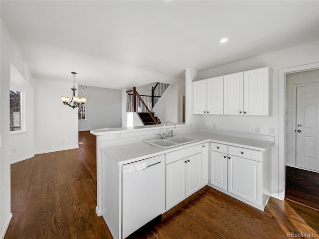 kitchen with kitchen peninsula, dishwasher, white cabinets, and sink