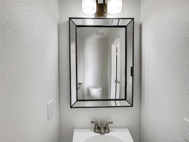 bathroom featuring toilet and sink