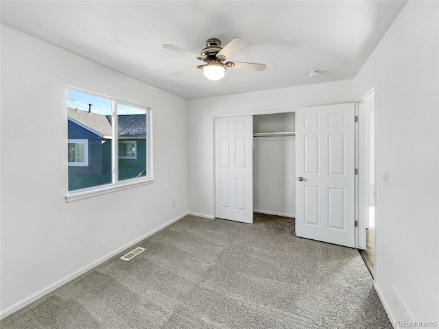 unfurnished bedroom with ceiling fan, carpet floors, and a closet