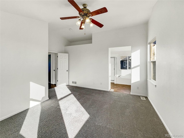 carpeted empty room featuring ceiling fan and lofted ceiling