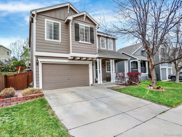 view of front facade with a porch, a front yard, fence, concrete driveway, and an attached garage