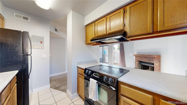 12360 W Nevada Pl Unit 101, Lakewood, CO 80228 - kitchen with black appliances, under cabinet range hood, light countertops, and a fireplace