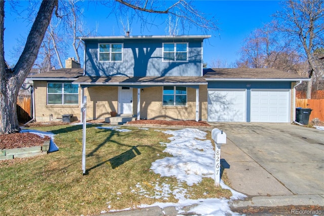 view of front of house featuring a garage and a front lawn