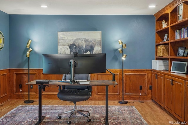 home office with light hardwood / wood-style flooring