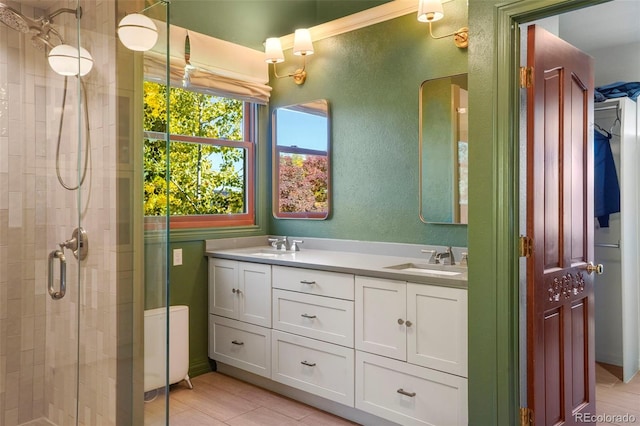 bathroom with a shower with door and vanity