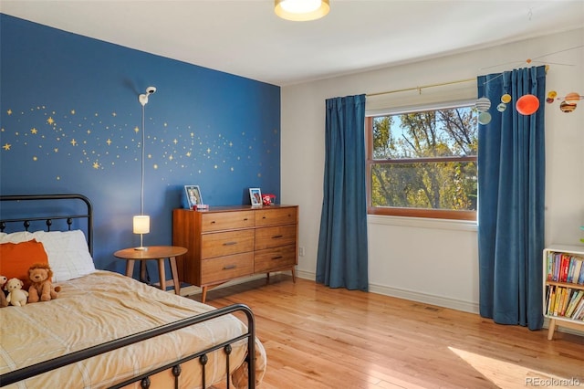 bedroom with hardwood / wood-style floors