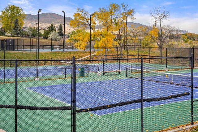 view of tennis court with a mountain view