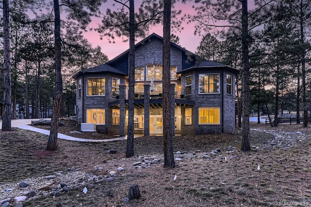 back house at dusk with a balcony