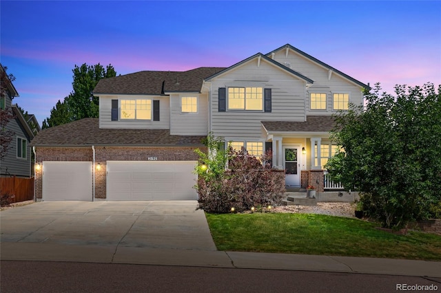 2192 Paint Pony Cir, Castle Rock, CO 80108 - view of front of home with concrete driveway, a yard, a shingled roof, brick siding, and an attached garage