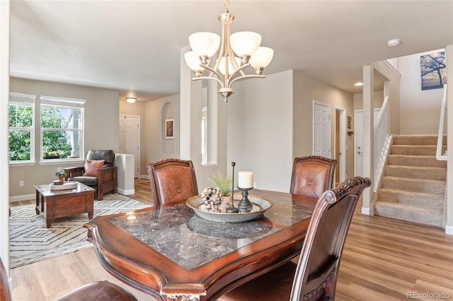 2192 Paint Pony Cir, Castle Rock, CO 80108 - dining space featuring light wood-type flooring, stairs, and a chandelier