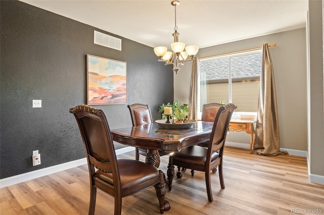 2192 Paint Pony Cir, Castle Rock, CO 80108 - dining room with a textured wall, light wood finished floors, and a chandelier