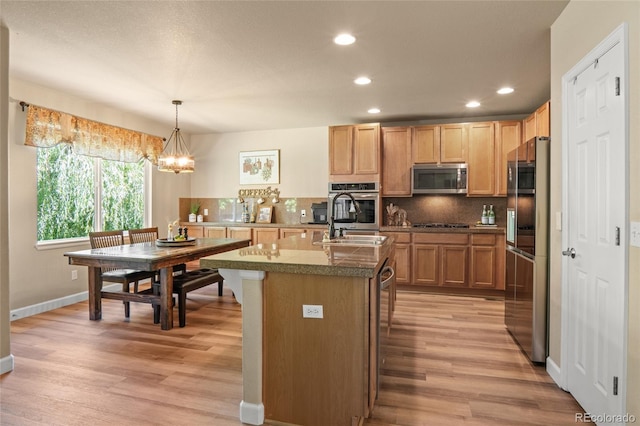 2192 Paint Pony Cir, Castle Rock, CO 80108 - kitchen featuring stainless steel appliances, tile countertops, light wood-style flooring, recessed lighting, and backsplash