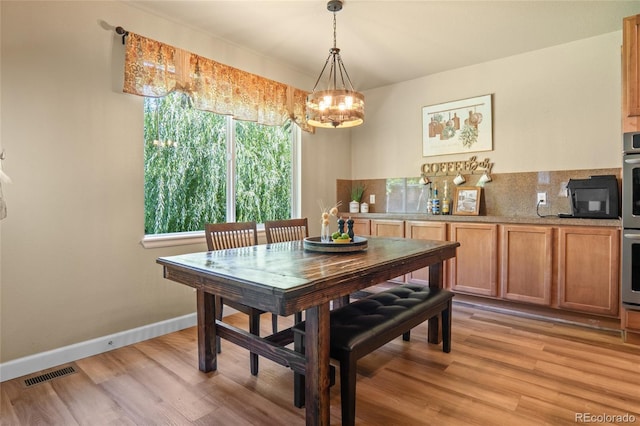 2192 Paint Pony Cir, Castle Rock, CO 80108 - dining area with a chandelier and light wood finished floors