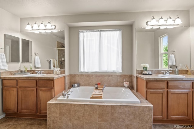 2192 Paint Pony Cir, Castle Rock, CO 80108 - bathroom featuring two vanities, a bath, a shower, and tile patterned floors