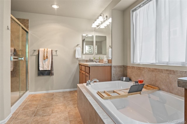 2192 Paint Pony Cir, Castle Rock, CO 80108 - bathroom featuring vanity, a garden tub, a stall shower, and tile patterned floors