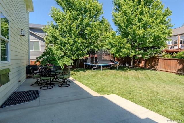 2192 Paint Pony Cir, Castle Rock, CO 80108 - fenced backyard featuring a trampoline, a patio, and outdoor dining space