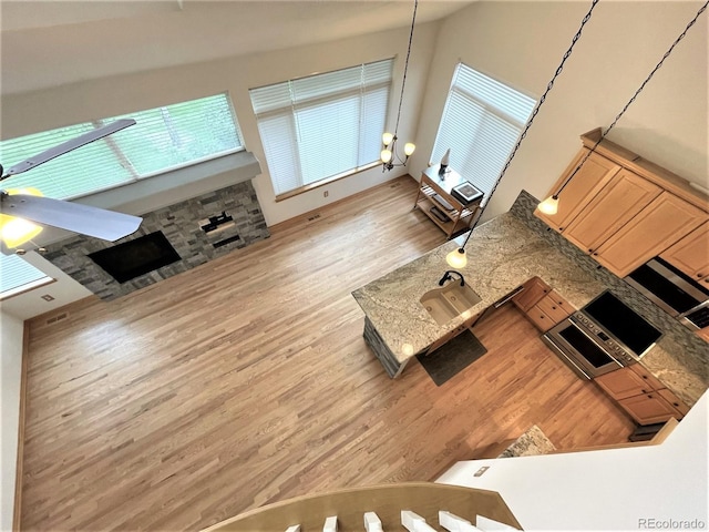 unfurnished living room with a sink and wood finished floors