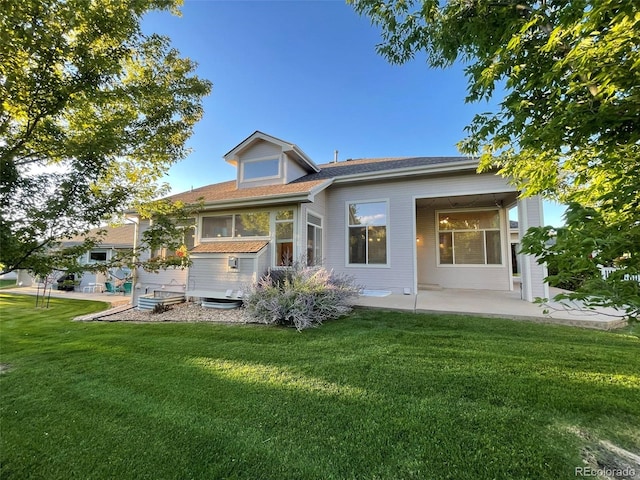 rear view of house with a patio area and a lawn