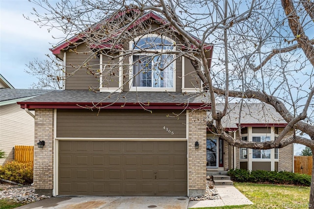 view of front of house featuring roof with shingles, fence, brick siding, and concrete driveway