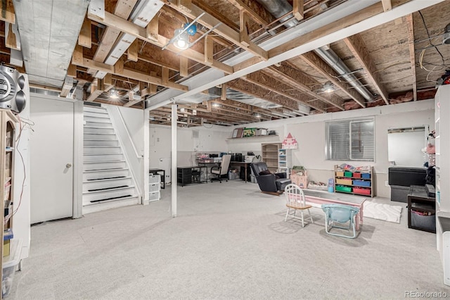 unfinished below grade area featuring stairs and carpet
