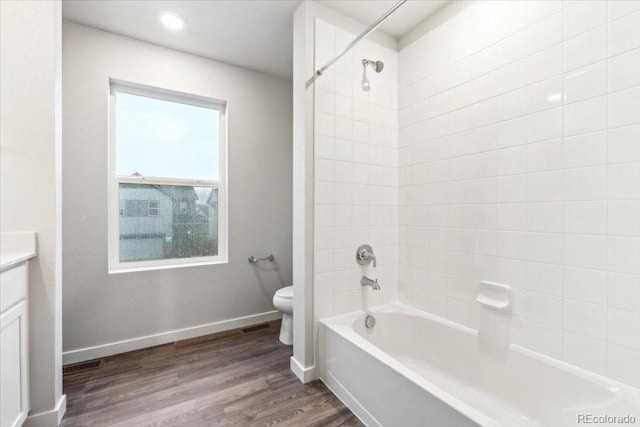 19018 E 94th Pl, Commerce City, CO 80022 - full bathroom featuring toilet, vanity, shower / tub combination, wood finished floors, and baseboards