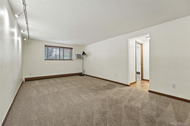1045 N Clarkson St Unit 102, Denver, CO 80218 - carpeted empty room featuring baseboards and a wall unit AC