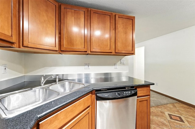 1045 N Clarkson St Unit 102, Denver, CO 80218 - kitchen featuring stainless steel dishwasher, brown cabinets, and dark countertops