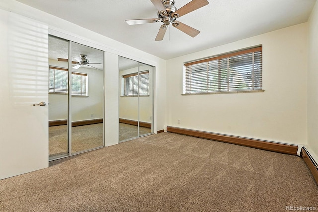 1045 N Clarkson St Unit 102, Denver, CO 80218 - carpeted spare room featuring baseboard heating and a ceiling fan