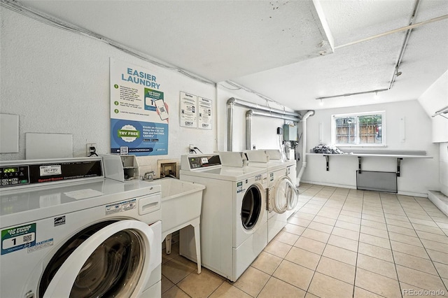 1045 N Clarkson St Unit 102, Denver, CO 80218 - community laundry room featuring washing machine and clothes dryer, light tile patterned flooring, and a textured ceiling