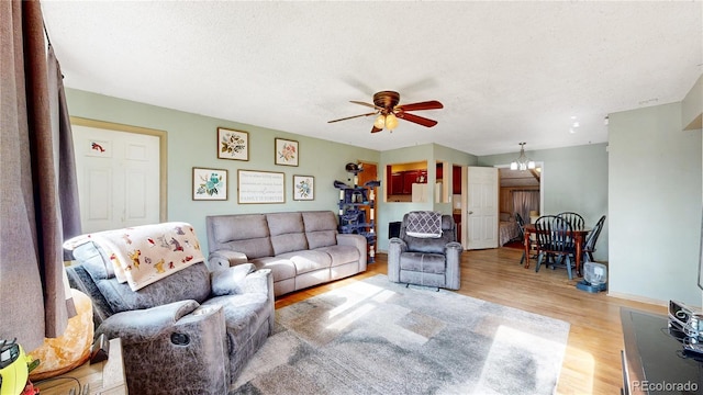 41 S Fenton St, Lakewood, CO 80226 - living area featuring light wood-style flooring, ceiling fan, a chandelier, and a textured ceiling