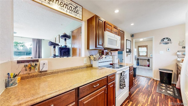 41 S Fenton St, Lakewood, CO 80226 - kitchen featuring white appliances, healthy amount of natural light, dark wood-style flooring, brown cabinets, and recessed lighting