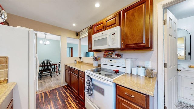 41 S Fenton St, Lakewood, CO 80226 - kitchen featuring white appliances, dark wood finished floors, light countertops, recessed lighting, and brown cabinets