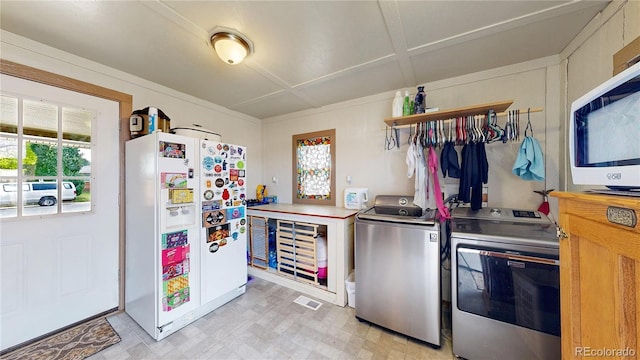 41 S Fenton St, Lakewood, CO 80226 - kitchen featuring white refrigerator with ice dispenser, separate washer and dryer, light floors, and light countertops