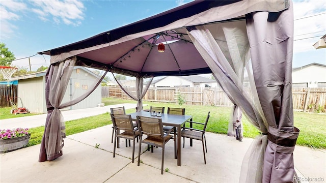 41 S Fenton St, Lakewood, CO 80226 - fenced backyard featuring a gazebo, a patio area, outdoor dining space, and a shed