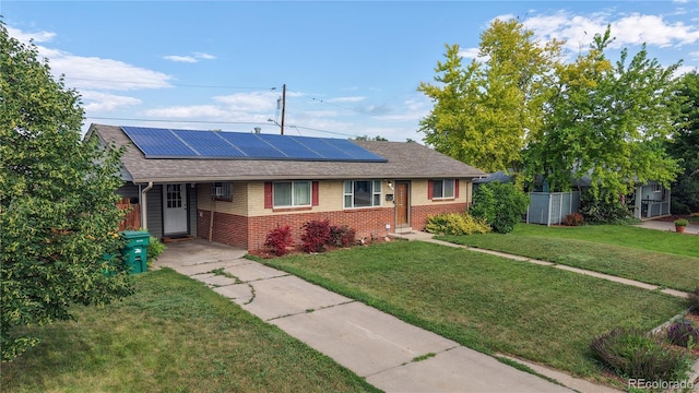 41 S Fenton St, Lakewood, CO 80226 - ranch-style house featuring brick siding, roof mounted solar panels, and a front lawn