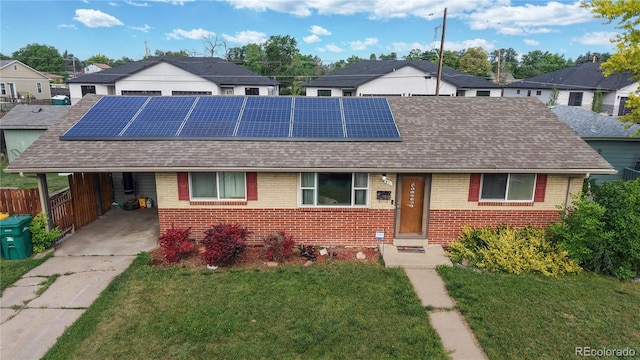41 S Fenton St, Lakewood, CO 80226 - view of front of home featuring brick siding, a residential view, and solar panels