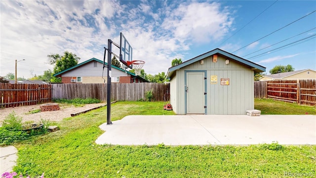 41 S Fenton St, Lakewood, CO 80226 - view of shed with a fenced backyard and an outdoor fire pit