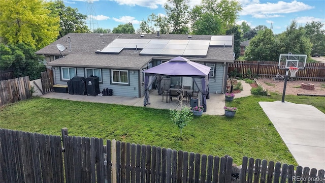41 S Fenton St, Lakewood, CO 80226 - rear view of house featuring solar panels, roof with shingles, a patio area, and a gazebo